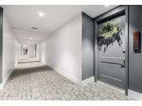 Well-lit hallway featuring patterned carpeting and access to various units, enhanced by neutral wall colors at 3131 N Central Ave # 6010, Phoenix, AZ 85012