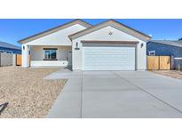 Charming single-story home with a well-maintained facade, two-car garage and desert landscaping at 32017 N Redding St, Wittmann, AZ 85361