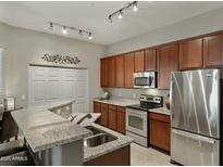 Open kitchen with granite countertops, stainless steel appliances, breakfast bar, and recessed lighting at 3330 S Gilbert Rd # 2021, Chandler, AZ 85286