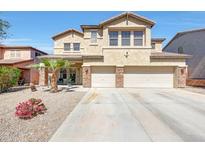 Spacious two-story home featuring a three-car garage, desert landscaping, and a well-maintained lawn at 4138 N 298Th Ln, Buckeye, AZ 85396