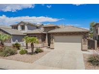 Charming single-story home features a two-car garage and decorative stone exterior at 43828 W Roth Rd, Maricopa, AZ 85138