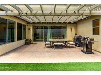 Outdoor patio area with a pergola, grill, and dining set, perfect for entertaining at 4495 E Woodside Way, Gilbert, AZ 85297