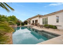 Relaxing backyard oasis with a refreshing swimming pool and ample lounge seating at 6694 S Banning St, Gilbert, AZ 85298
