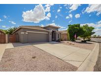 Home exterior featuring a well-maintained yard, long driveway, and neutral stucco at 81 E Rock Wren Dr, San Tan Valley, AZ 85143