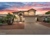 Inviting two-story home featuring a tile roof, desert landscaping, and a two car garage at 9225 E Pine Valley Rd, Scottsdale, AZ 85260