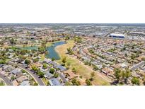High aerial view of the community showcasing lush green spaces, a lake, and residential areas at 11627 S Jokake St, Phoenix, AZ 85044