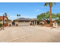 Beautiful home with a spacious driveway, two car garage, desert landscaping and solar panels at 14818 N 10Th St, Phoenix, AZ 85022