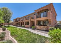 Inviting condo exterior with well-maintained landscaping, stone accents, and private balconies at 21655 N 36Th Ave # 121, Glendale, AZ 85308