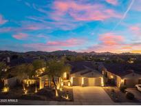 Breathtaking aerial view of the home showcasing the neighborhood, mountain views and colorful sunset at 12428 S 179Th Ln, Goodyear, AZ 85338