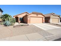 Charming single-story home with desert landscaping and attached two-car garage at 14912 W Lamoille Dr, Surprise, AZ 85374