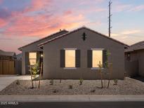 Charming single-story home featuring a red tile roof, desert landscaping, and shuttered windows at 322 S San Christo Ln, Casa Grande, AZ 85194