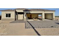 Home exterior featuring a spacious three-car garage and a charming paver driveway, offering curb appeal at 4160 N Tamarax Dr, Eloy, AZ 85131