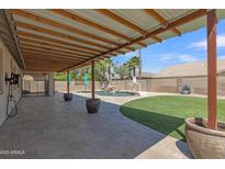 Inviting backyard showcasing a covered patio area overlooking a pool and lush lawn at 4968 E Westchester Dr, Chandler, AZ 85249
