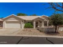 Charming single-story home featuring low-maintenance landscaping and an attached two-car garage at 15460 W Amelia Dr, Goodyear, AZ 85395