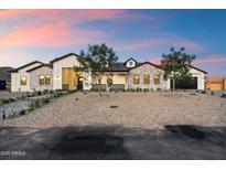 Stunning exterior with stone accents and modern design under a gorgeous sunset sky at 3323 N 81St St, Mesa, AZ 85207