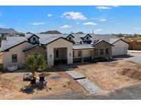 Charming home with dormer windows, paver driveway, and white and stone facade at 3323 N 81St St, Mesa, AZ 85207