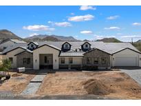 Charming exterior with stone accents, dormer windows, and a paver driveway at 3323 N 81St St, Mesa, AZ 85207