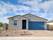 Charming single-story home featuring a blue garage door, desert landscaping, and a welcoming entrance at 4151 W Lisa Ln, San Tan Valley, AZ 85144