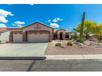 Charming single-story home with a three-car garage and desert landscaping at 5381 S Emerald Desert Dr, Gold Canyon, AZ 85118