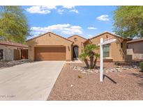 Charming single-story home featuring a two-car garage, desert landscaping, and a 'coming soon' sign at 5408 W Allen St, Laveen, AZ 85339