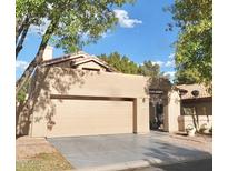 Tan home with a two car garage, a tile roof, and minimal landscaping at 8863 S Grandview Dr, Tempe, AZ 85284
