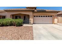 Charming single-story home with a tile roof, low-maintenance landscaping, and a two-car garage at 12238 W Monroe St, Avondale, AZ 85323