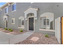 Inviting townhome exterior with a covered entryway and desert-friendly landscaping at 2402 E 5Th St # 1621, Tempe, AZ 85288