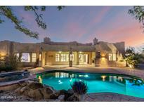 Beautiful backyard pool and spa with lush landscaping creating a private oasis for relaxation at 43 E Desert Hills Dr, Phoenix, AZ 85086