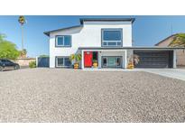 Stunning two-story home with a red front door and desert landscaping at 4530 W Paradise Dr, Glendale, AZ 85304