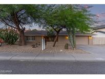 Inviting single-story home featuring desert landscaping, a two-car garage, and neutral paint at 5008 E Nisbet Rd, Scottsdale, AZ 85254