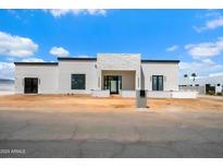 Modern home with white stone accents, black trim, and minimalist design at 6202 E Larkspur Dr, Scottsdale, AZ 85254
