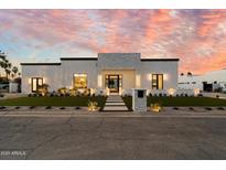 Stunning home featuring a stone facade, professional landscaping, and a walkway leading to the front door at 6202 E Larkspur Dr, Scottsdale, AZ 85254