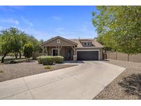 Charming single-story home featuring a well-manicured yard and a two-car garage in a Gathering-friendly neighborhood at 865 E Rojo Ct, Gilbert, AZ 85297