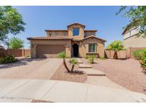Charming two-story home with a well-manicured front yard and a brick-paved driveway at 11466 N 162Nd Ln, Surprise, AZ 85379