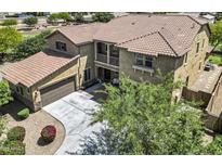 Stunning two-story home featuring a tile roof, private balcony, and a spacious three-car garage at 19943 E Strawberry Dr, Queen Creek, AZ 85142