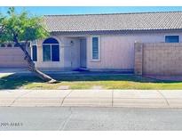 Charming single-story home with well-maintained landscaping and a unique tree in the front yard at 2221 E Union Hills Dr # 157, Phoenix, AZ 85024
