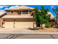 Charming two-story home with a three-car garage and a well-maintained yard with mature landscaping at 23829 N 59Th Dr, Glendale, AZ 85310