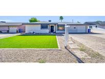 Charming single-story home featuring an inviting, easy-care artificial turf lawn at 2410 N 40Th St, Phoenix, AZ 85008