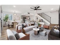 Bright living room showcasing a spacious layout, modern decor, and seamless flow to the kitchen and staircase at 2625 W Ocotillo Rd # 4, Phoenix, AZ 85017