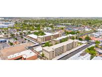 Expansive aerial view of a well-maintained community with mature trees and convenient parking at 349 E Thomas Rd # E401, Phoenix, AZ 85012