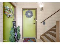 Inviting entryway features decorative wreaths and welcome sign by the front door at 349 E Thomas Rd # E401, Phoenix, AZ 85012