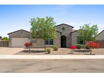 Charming single-story home with desert landscaping, a two-car garage and an arched entryway at 4671 N 185Th Ln, Goodyear, AZ 85395