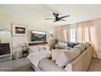 Cozy living room with a large sectional couch, modern decor, and lots of natural light at 6005 N Granite Reef Rd, Scottsdale, AZ 85250
