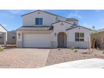 Charming two-story home with a well-manicured front yard and a two-car garage at 8865 W Orange Dr, Glendale, AZ 85305