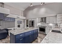 Stylish kitchen with a large island, stainless steel appliances, and a breakfast nook at 9736 E Ironwood Dr, Scottsdale, AZ 85258