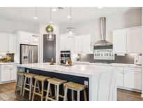 Gourmet kitchen with a large island, stainless steel appliances, and ample counter space at 22848 N 98Th Dr, Peoria, AZ 85383