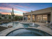 Relaxing backyard pool and spa area with a waterfall feature and comfortable lounge chairs at 30813 N 138Th St, Scottsdale, AZ 85262