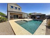Home featuring a pristine pool, cozy patio seating, well-manicured landscaping, and a gazebo, perfect for outdoor enjoyment at 31077 W Cheery Lynn Rd, Buckeye, AZ 85396