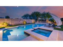 Inviting swimming pool and hot tub, ideal for relaxing and unwinding in your private backyard oasis at 3933 E Alfalfa Dr, Gilbert, AZ 85298