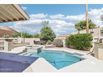 Enjoy a private backyard oasis with a sparkling pool, spa, and outdoor dining area at 7734 E Rose Ln, Scottsdale, AZ 85250